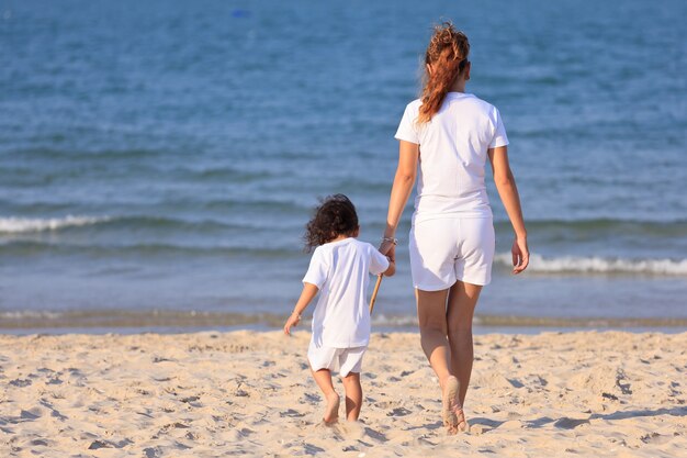 Asian family play on tropical beach