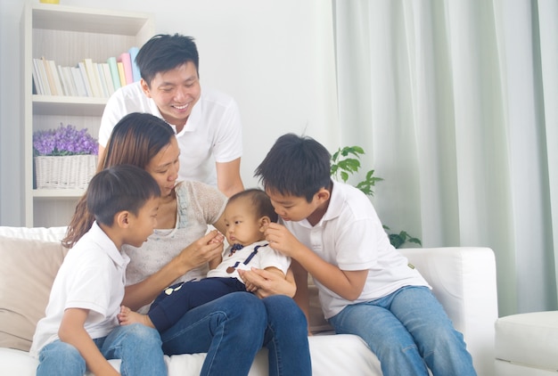 Asian family playing with baby