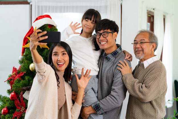 Asian Family selfie with a Christmas tree