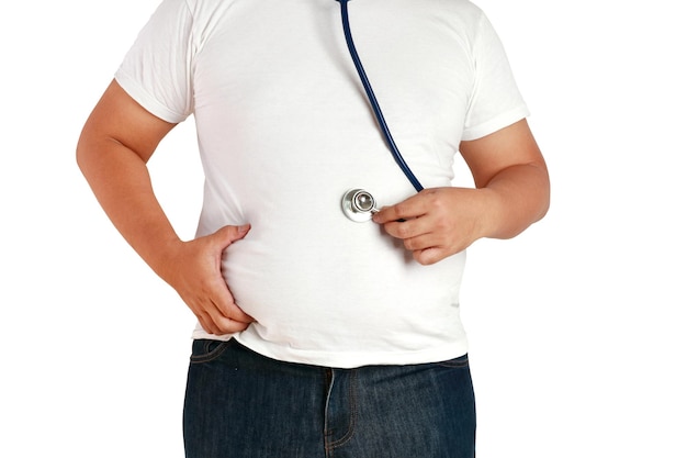 Asian fat men use their hands to squeeze their abdomen and use a stethoscope to check the body. He is overweight and is the cause of many diseases. Health care concept ,Clipping path, White background