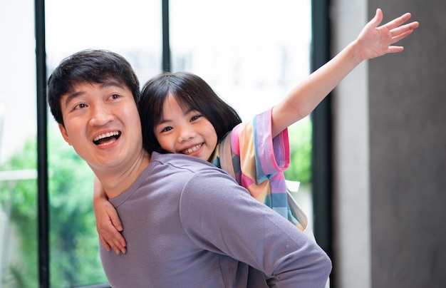 Asian father and daughter at home