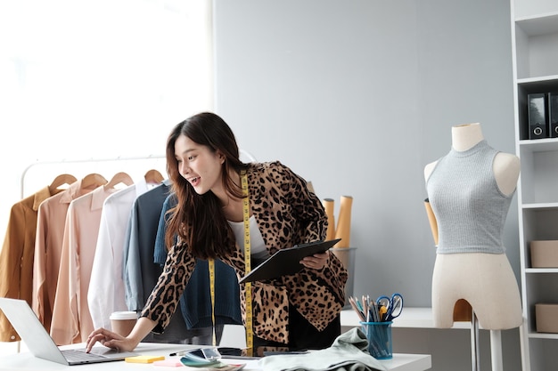 Asian female clothing designer working inside office