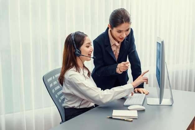 Asian female customer support operator guided by manger Enthusiastic