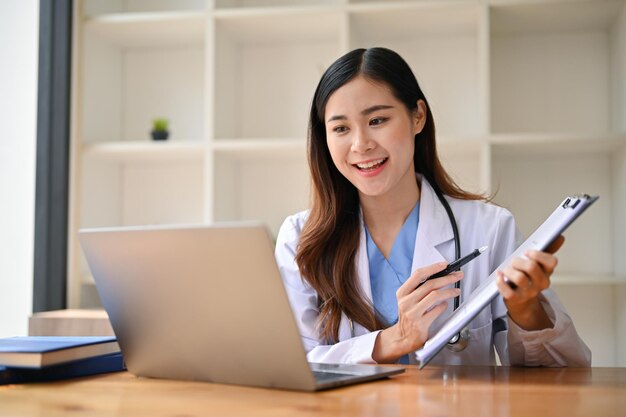 An Asian female doctor having an online medical webinar with her team