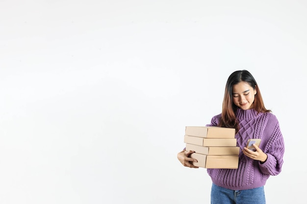 Asian Female Holding Cardboard Box Online Shopping on ECommerce using Smartphone