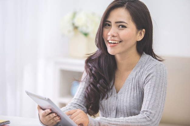 Asian female at home using tablet