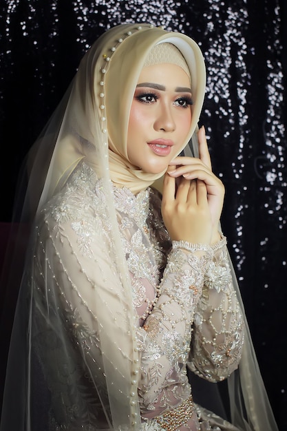 Asian female models wear simple Indonesian Muslim traditional wedding dresses