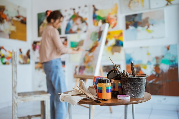 Photo asian female painter painting on canvas in her workshop