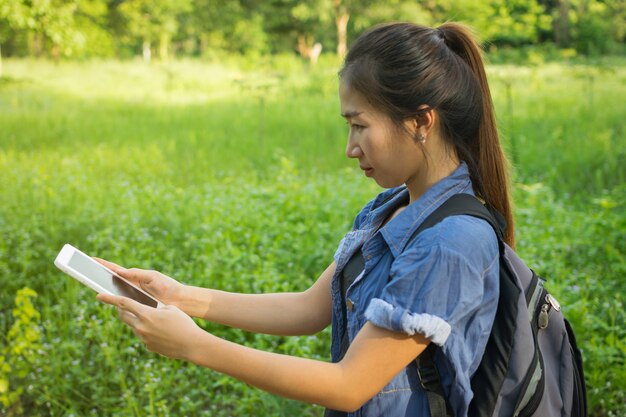 Asian female traveler and tablet