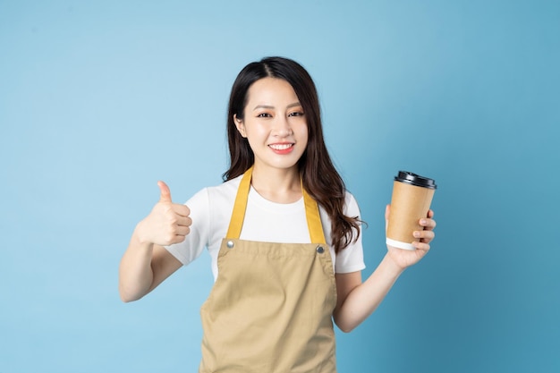 Asian female waitress portrait, isolated on blue background