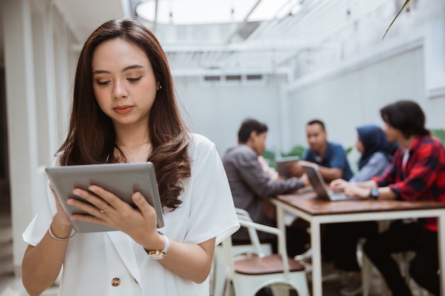 Asian female worker using tablet pc