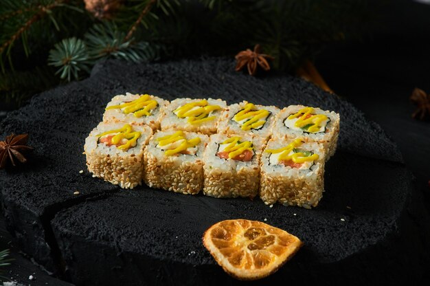 asian food delivery home, various sushi sets in plastic containers with sauces