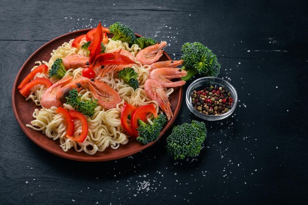 Asian food with seafood and vegetables Shrimp broccoli paprika spices Top view Free space for text