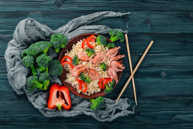 Asian food with seafood and vegetables Shrimp broccoli paprika spices Top view Free space for text