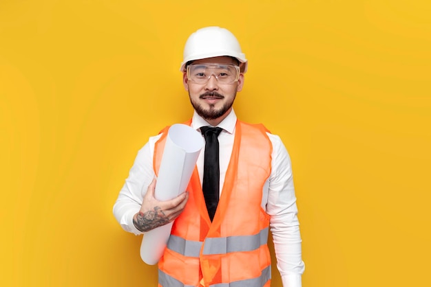 asian foreman in uniform with papers and projects on yellow isolated background