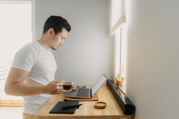 Asian freelancer man is thinking and working on his laptop. Concept of freelance creative works.