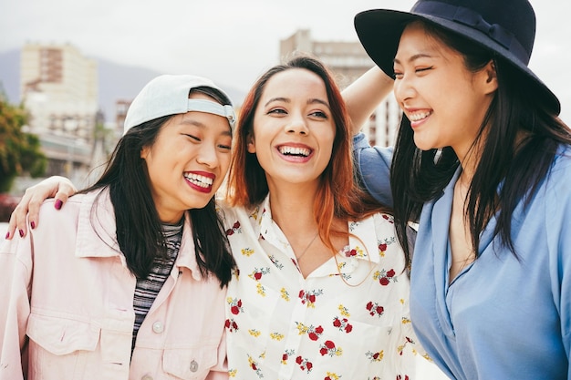 Asian friends having fun together outdoor Focus on center girl face