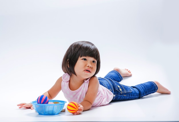 Photo asian girl boring to play color ball