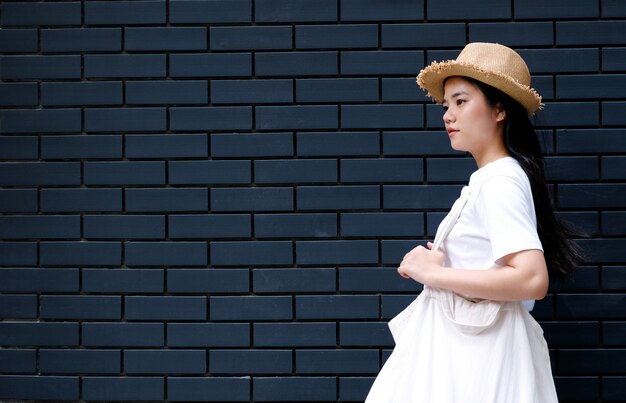 Asian girl on a dark wall background