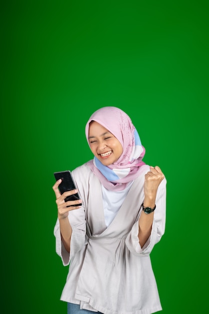 Asian girl excitedly when looking at mobile phone screen