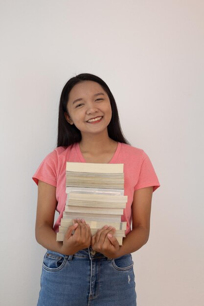 Photo asian girl hold book on her arm on whiye backgroundstudent girl