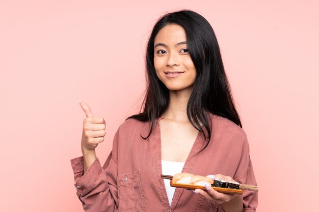 Asian girl holding a plate with sushi