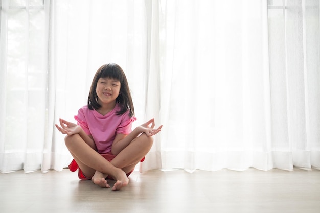 Asian girl meditating lovely kidxA