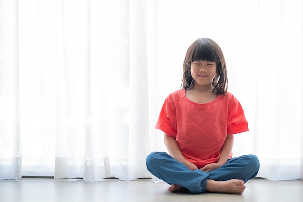 Asian girl meditating lovely kidxA