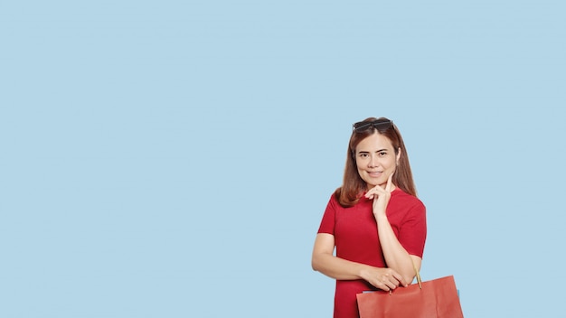 Asian girl in red dress with shopping bags