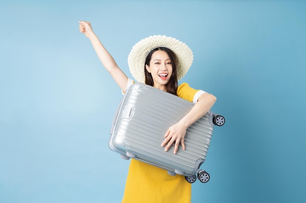 Asian girl traveling image, isolated on blue background