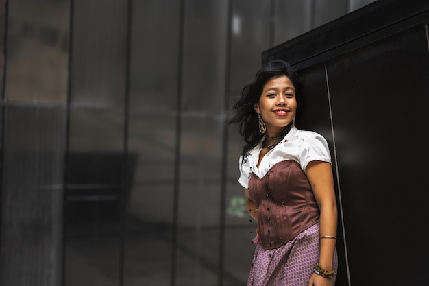 An Asian girl in a vintage Asian traditional long dress fashion photography on a black background