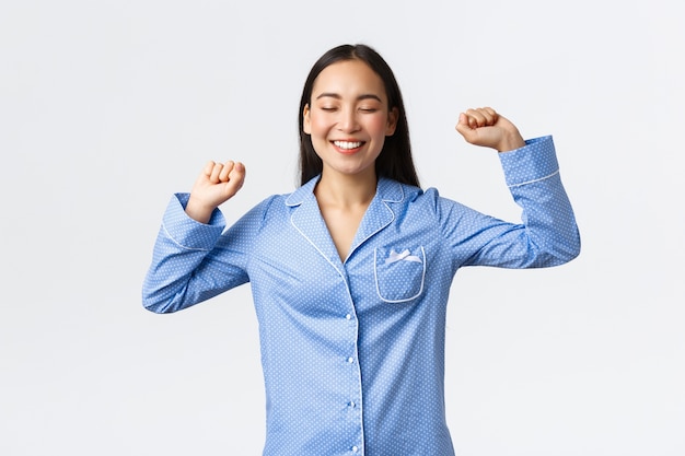 Asian girl wearing blue pajamas posing