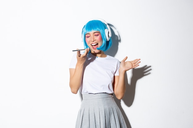 Asian girl wearing a blue wig posing