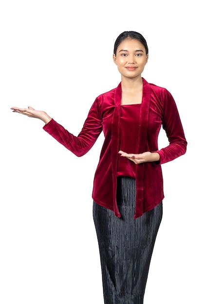 Asian girl wearing red kebaya traditional clothes with open palm hand showing something