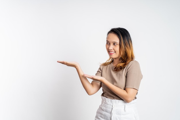 Asian girl with hand gesture presenting something on isolated