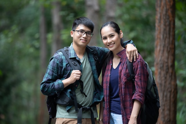 Asian Group of young people Hiking with friends backpacks walking travel on holiday  