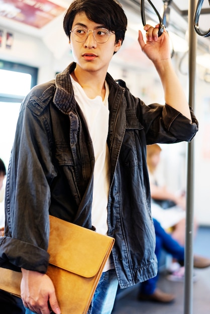 Asian guy stand bus trasporto pubblico