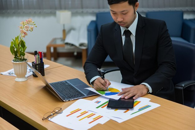 Asian handsom businessman working in the officeThailand peopleThinking for hard work with new project