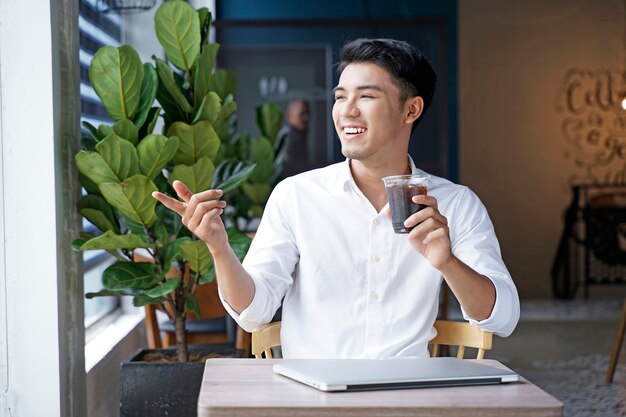 Asian handsome businessman or office worker working at coffee shop