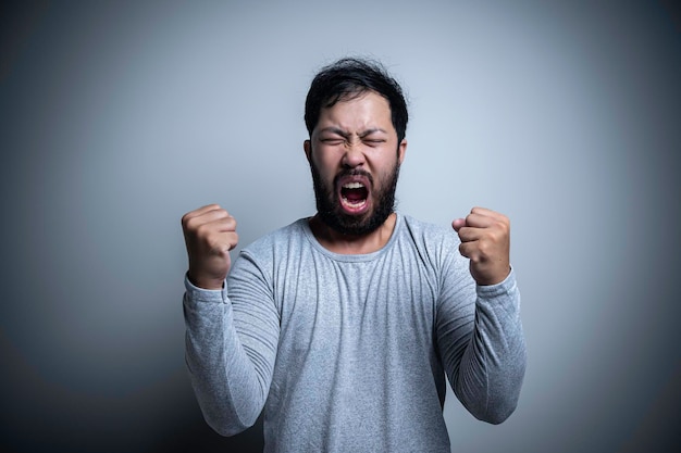 Asian handsome man angry on white backgroundPortrait of young Stress male concept