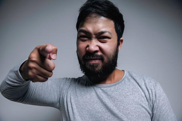 Asian handsome man angry on white backgroundportrait of young\
stress male concept