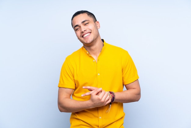 Asian handsome man over isolated background laughing