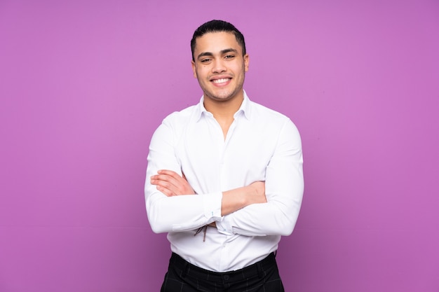 Asian handsome man isolated on blue background keeping the arms crossed in frontal position