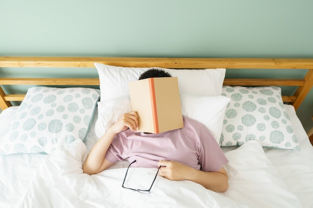 Asian handsome man Read books while sleeping.