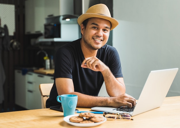 Asian handsome man work from home with laptop