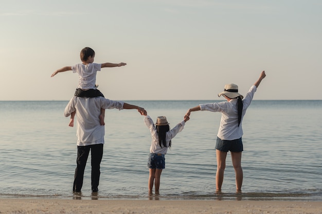 Asian happy family enjoy relaxing on the beach, Travel, vacation and lifestyle concept.