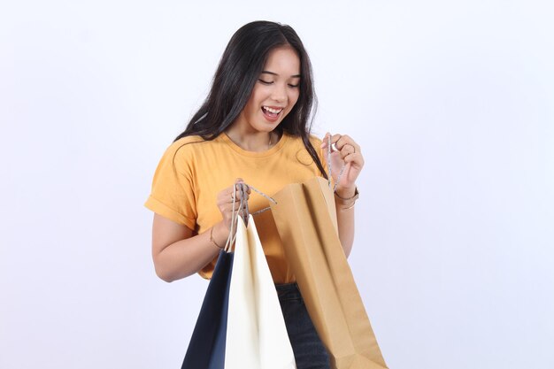 Asian happy female woman girl holds colourful shopping packages standing on white background