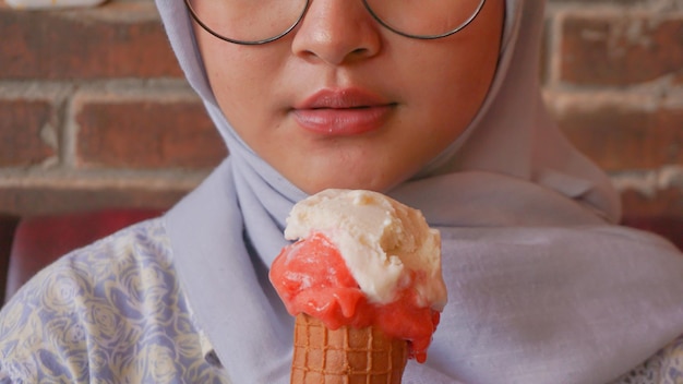 Asian hijab girl while enjoying gelato ice cream