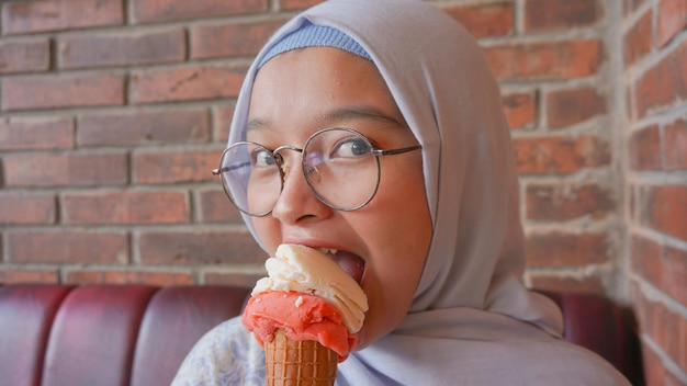 Asian hijab girl while enjoying gelato ice cream