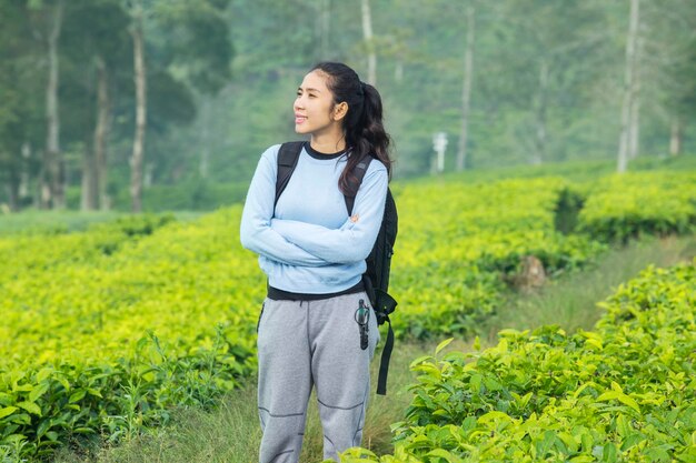 Asian hiker standing in the tea plantation